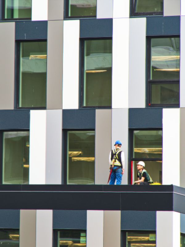 Construction workers reviewing plans on a UK site